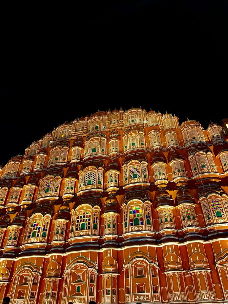 The lit facade of Hawa Mahal in Jaipur after dark