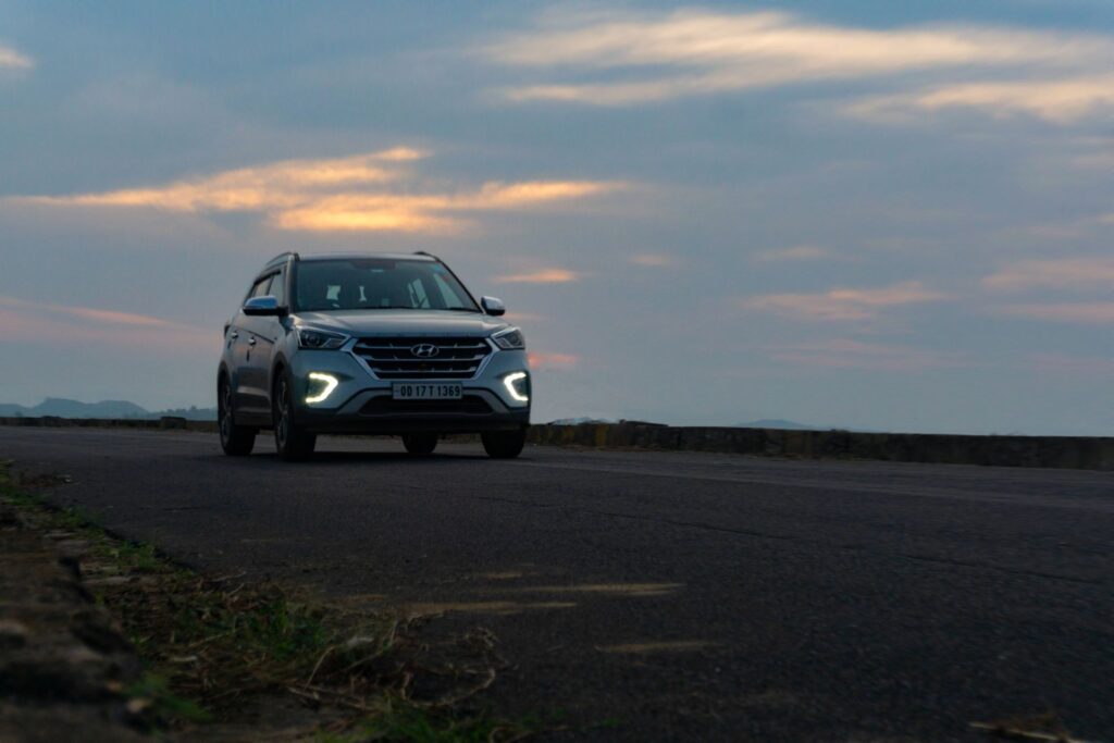 A car on an open Indian highway at sunset