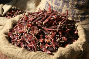 A sack of dried red chillies on a market table